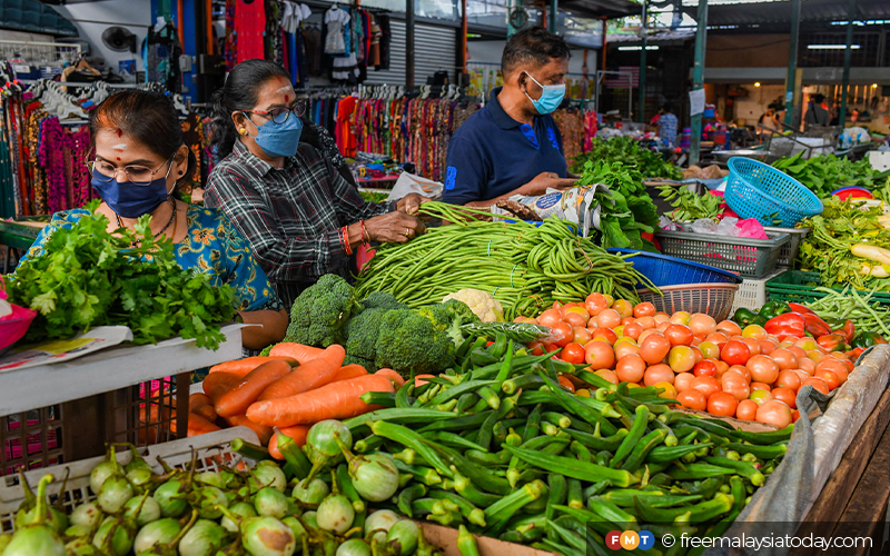 Malaysian Grocery Shoppers in a shopping frenzy at a Vegetable