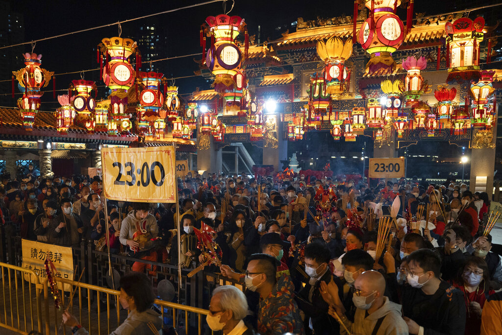 Chinese pray for health in Lunar New Year as Covid death toll rises