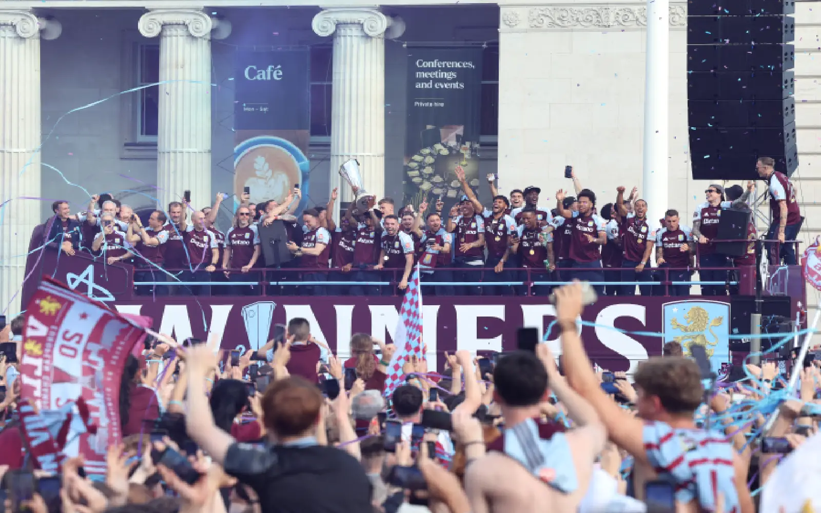 Aston Villa players wave from the bus during the team's trophy parade, the day after their team won the Europa League, in Birmingham, central England on May 21, 2026. Aston Villa's win in the Europa League puts an end to their 30-year trophy drought.